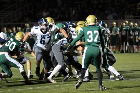 Senior varsity football lineman Ryan Farrell breaks through in pursuit of the opposing quarterback (Farrell courtesy photo).