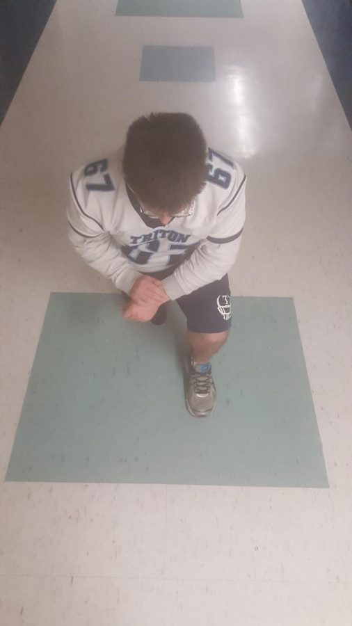 Ryan Farrol kneeling when asked to pose 