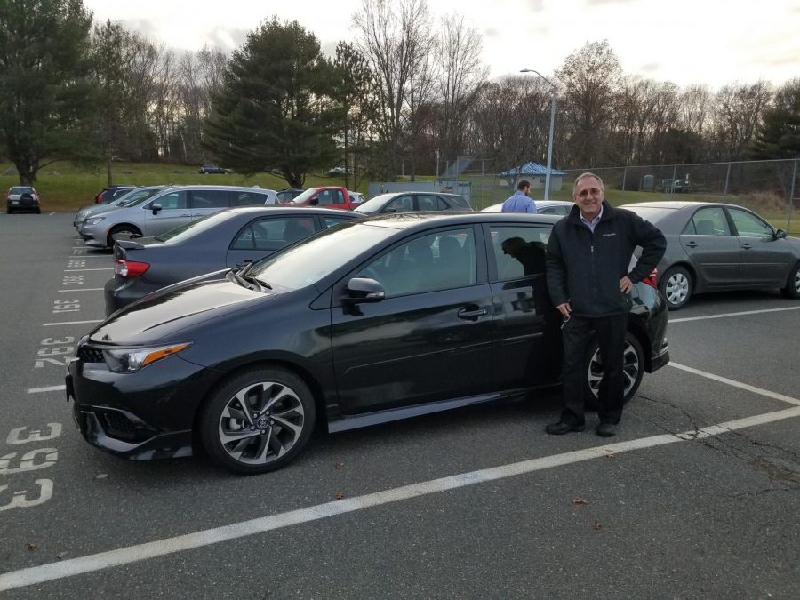 Mr. Dube standing next to his beloved new car the Corolla: Baiardi Photo