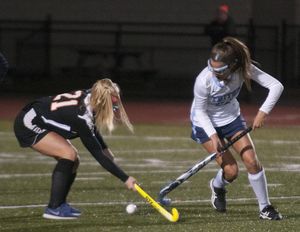 Gianna Conte protects the ball against an Ipswich defender in the Triton field hockey team’s state tournament game, which they won 5-0. Conte scored once. 
