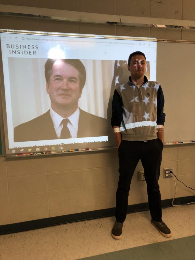 Mr. Galante stands before a projected image of Supreme Court Justice Brett Kavanaugh.