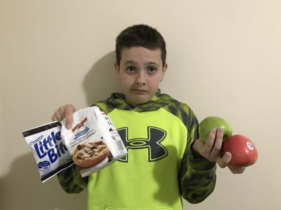 Student has trouble deciding if he should have a healthy snack or not