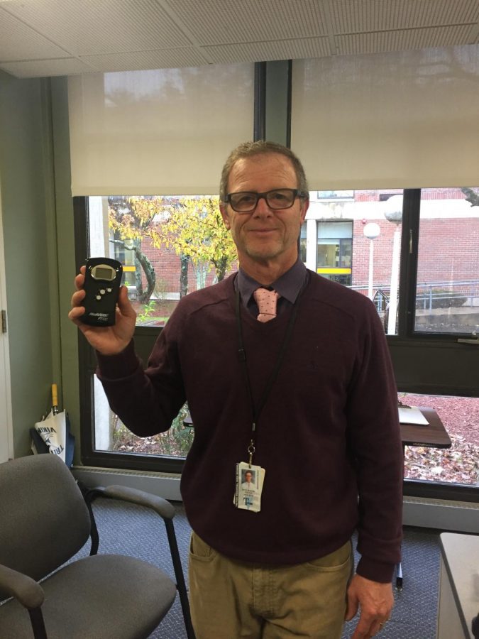 Brennan poses with the breathalyzer used at school dances