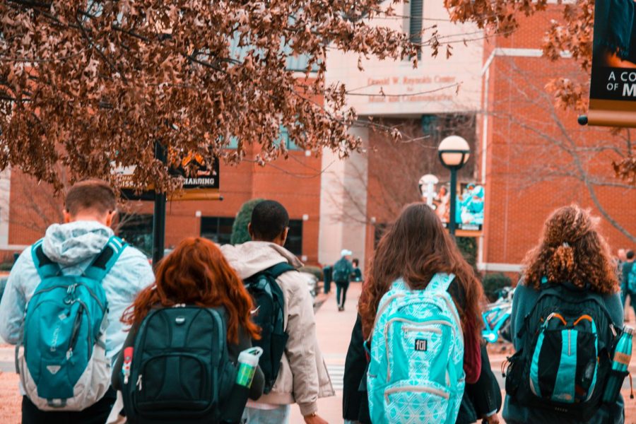 Students walking to school with their backpacks.