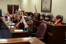 A school hosts a mock trial for the benefit of students learning about the court system.