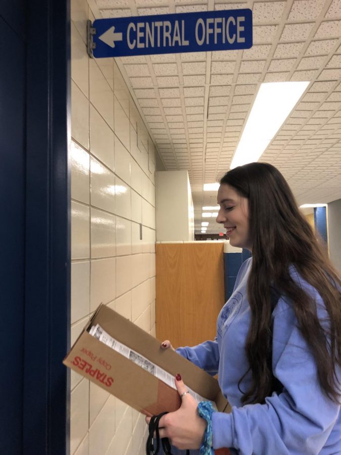 Senior Kelley Frithsen helps deliver more than 100 copies of the Triton Voice to the Main Office where it will be brought to Pine Grove and Salisbury Elementary!