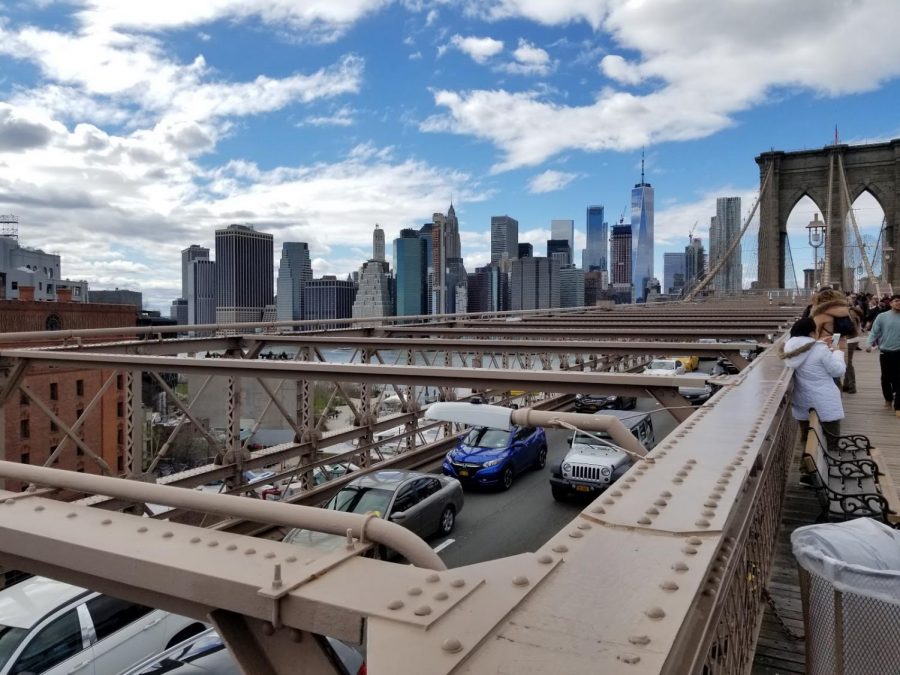 The view of New York City as seen from the Brooklyn Bridge. 