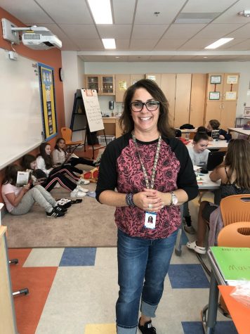 Mrs. Max poses in front of students hard at work on a Friday afternoon 