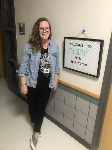 Kaitlyn Tilton standing outside of her warm, cheerful classroom at SES.