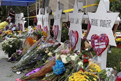 Flowers surround Stars of David as part of a makeshift memorial outside the Tree of Life Synagogue to the 11 people killed during worship services Saturday Oct. 27, 2018 in Pittsburgh.