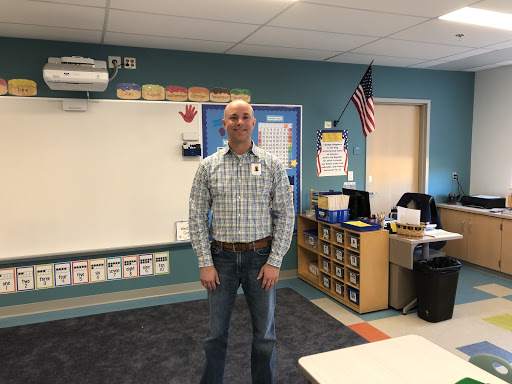 Kindergarten teacher Mr.Paul White stands in his new Pine Grove classroom.
