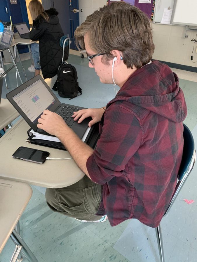 Junior Anthony Mariniello listens to music while doing work in Algebra 2. 
