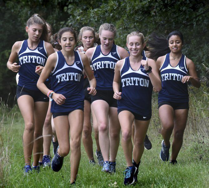 The Triton Girls Cross Country Team during the past season runs together.