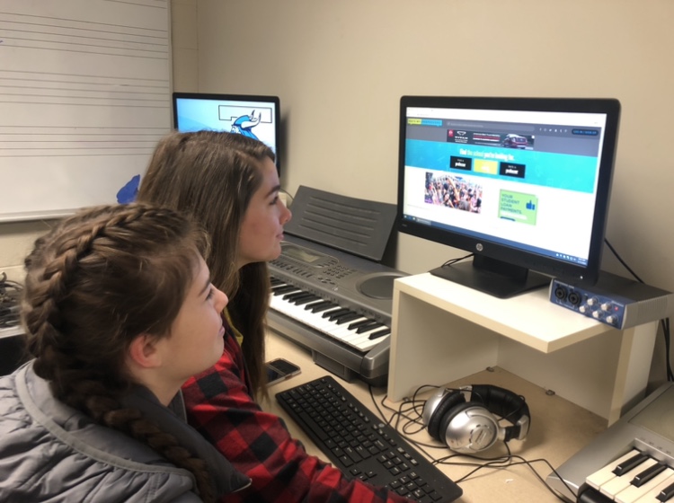 Junior Sammie Mariniello and Sophomore Olivia Rowe view an online assignment. Students screens are now visible to teachers through the Classwize app that can monitor student screentime.