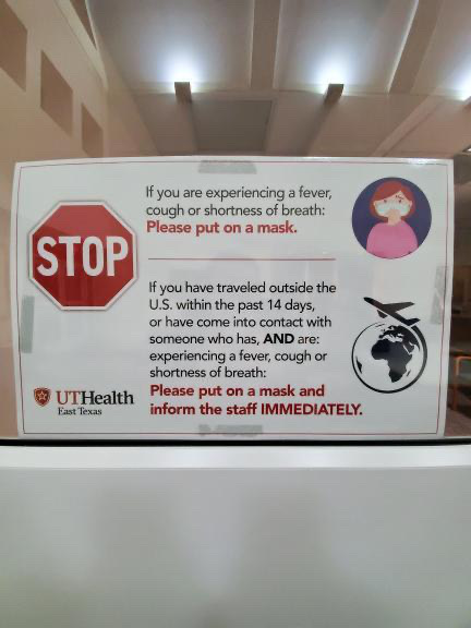 A sign in UTHealth East Texas Carthage telling people to be aware of symptoms.
