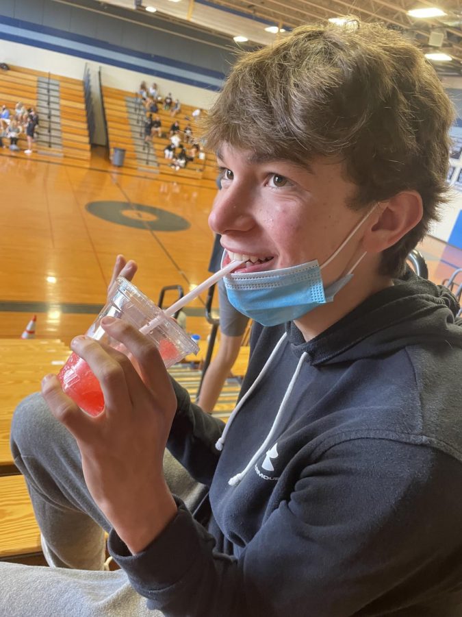 Triton student, Grant Schroeder slurps down his cherry slushy during 2nd lunch in the gym (Campbell photo).
