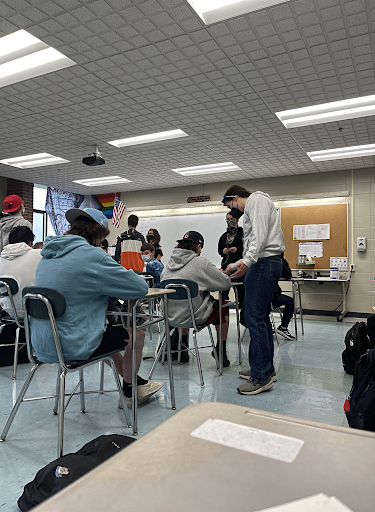 Mr. Takesian works one on one with a student who is trying to work through a challenging paper. 