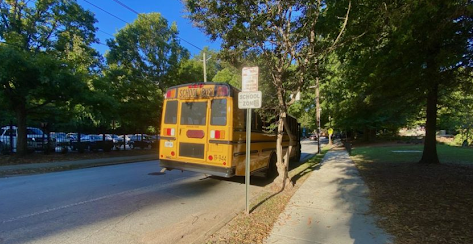 Bus dropping elementary students off at their stop at the end of the day.