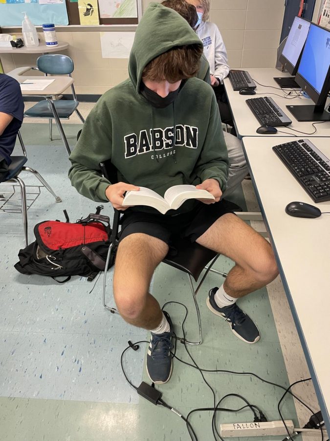 Senior+Kyle+Bouley+reading+a+book+instead+of+using+his+phone.
