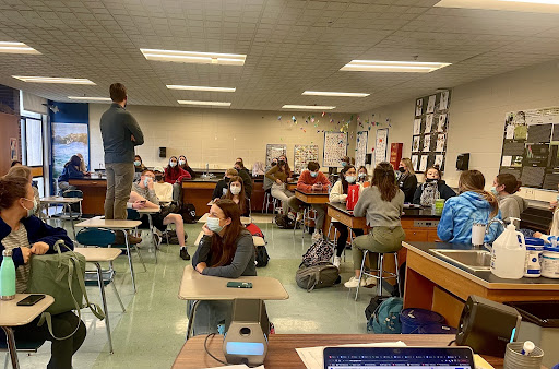 Students listen as Mr. Horsley makes an announcement to the club