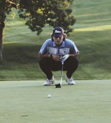 Braeden McDonald lines up his put on the 7th green at Olde Newbury golf course. 