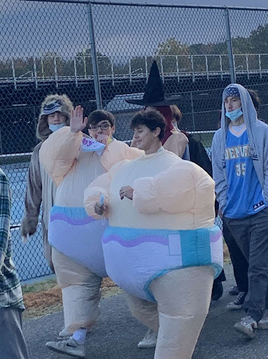 Two seniors dressed as sumo wrestlers walk in Tritons Halloween parade