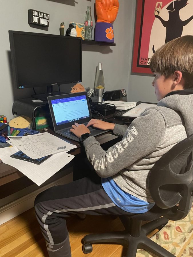 Triton 7th Grader, Foster Campbell, using his school chromebook for homework.