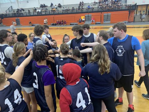 Unified Basketball team gathers around to seek a game plan for the game.