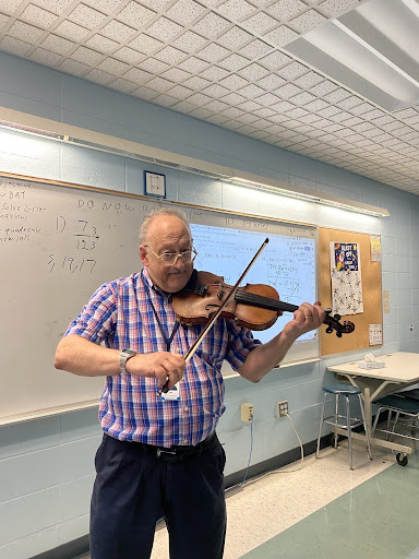 Aram Hollman plays the fiddle for his A Period class.