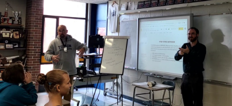 Mr. colbert giving his morning greeting and Mr. E signs what hes saying to the deaf student in front of him