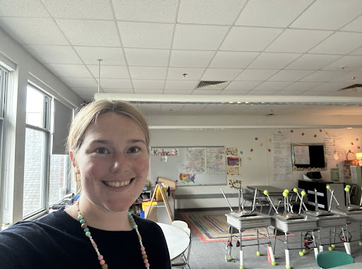 New teacher Kathryn Schroeder poses in front of her new classroom 