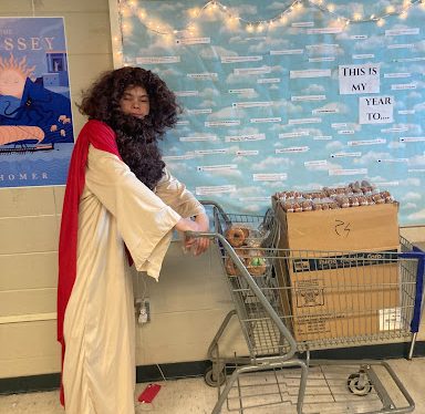 The top buyer of the donuts, Dominic Karpenko, has also taken things to a new level this year, donning a wig, beard, and toga to become the Donut Jesus who gives away the treat to students.