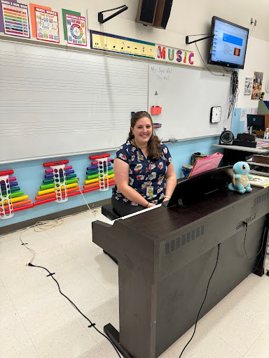 Ms. Megan Speidel at her piano in her new classroom. 