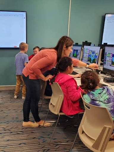 Above: Teacher Erin Kelley assisting one of her students in her library at Pine Grove.