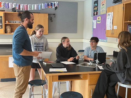 Photo of Drew Balonoff teaching a group of 7th graders in his classroom.
