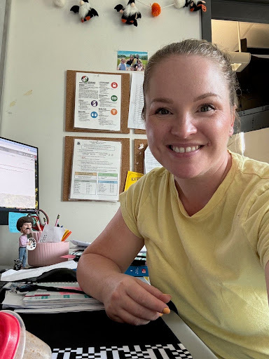 Mrs. DiResta sitting at her desk in her classroom