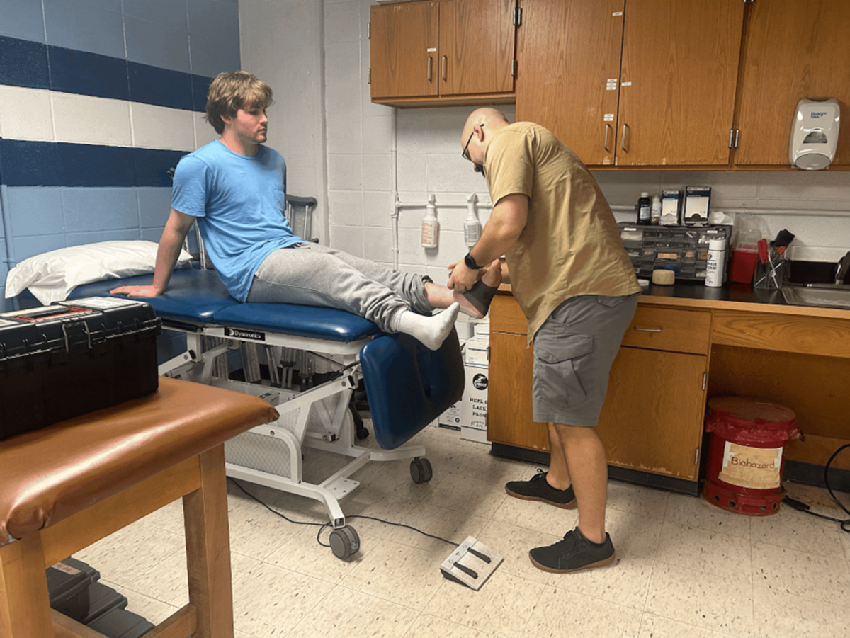 Trainer Mike Ruzycky helping student Christian Conroy in a pre-practice exam.
