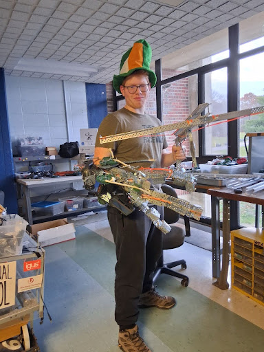 Captain Luke Aham, with some of his inventions, is a key member of the robotics team.