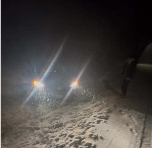 A student's car struggles to get out of the snow after veering off the road during a recent storm. The North Shore of Massachusetts has experienced a greater than usual number of snow days this winter season.