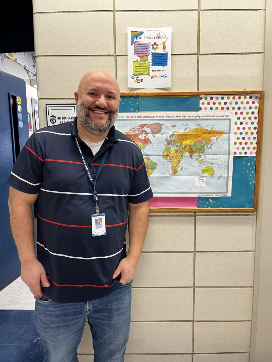 Richard in front of his classroom door