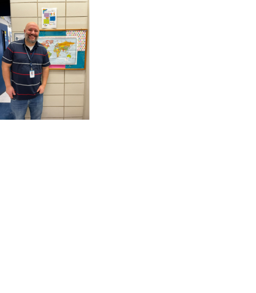 Richard in front of his classroom,