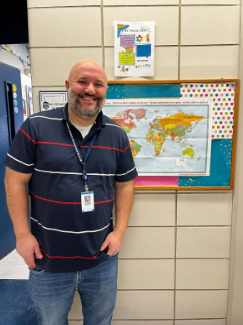 Richard in front of his classroom, 
